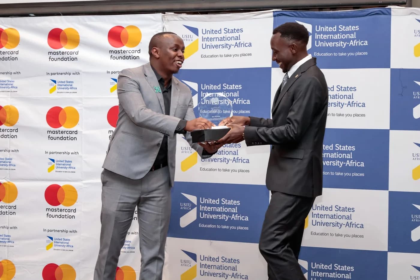Eric receiving an award at a USIU-Africa event